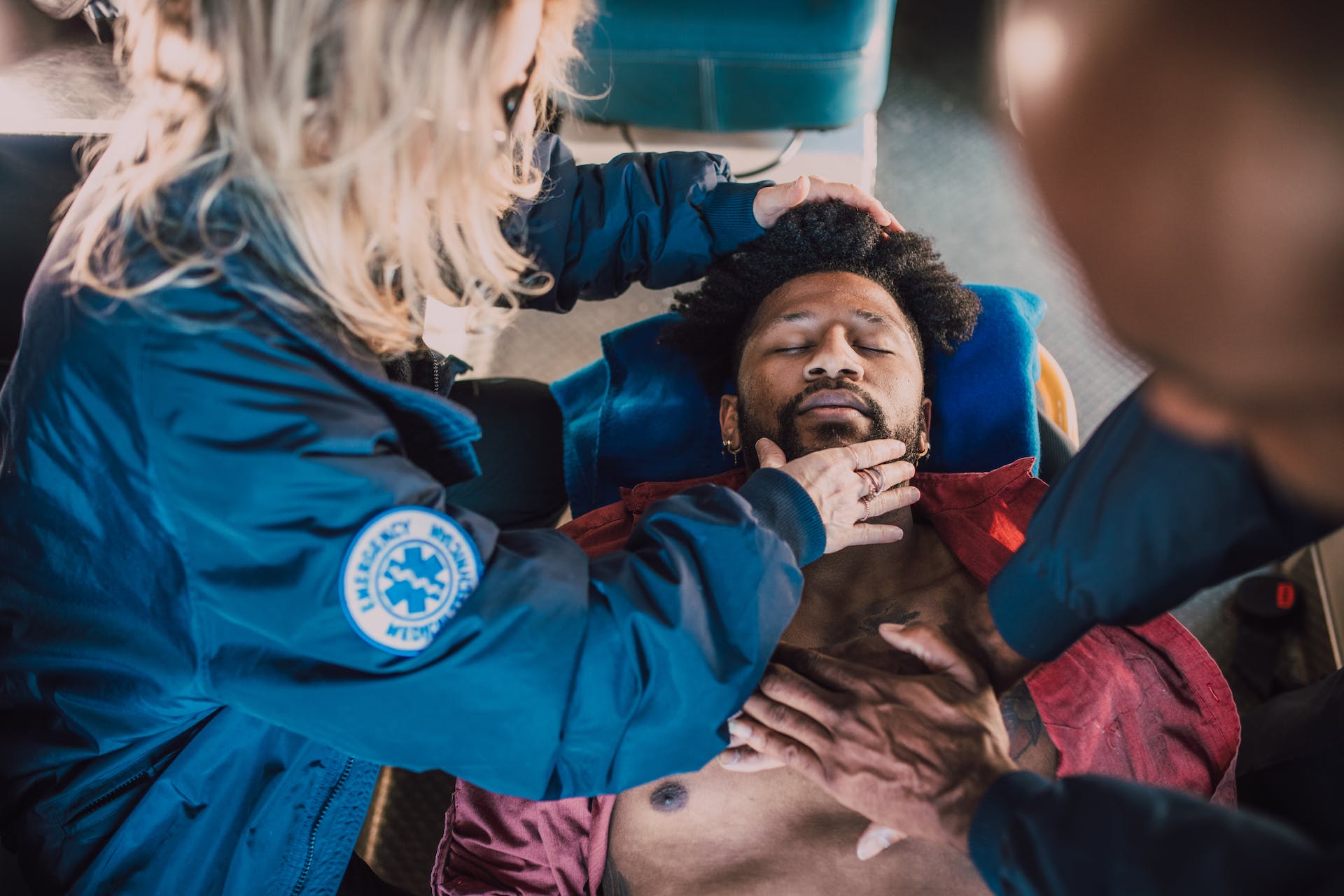 EMT attending to unconscious man